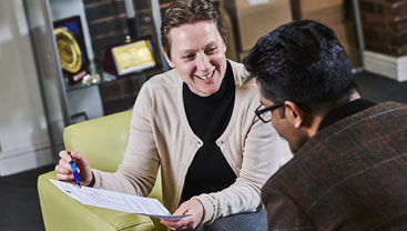A student going through the application process with a staff member