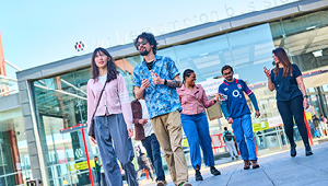 Group of students walking away from the bus station