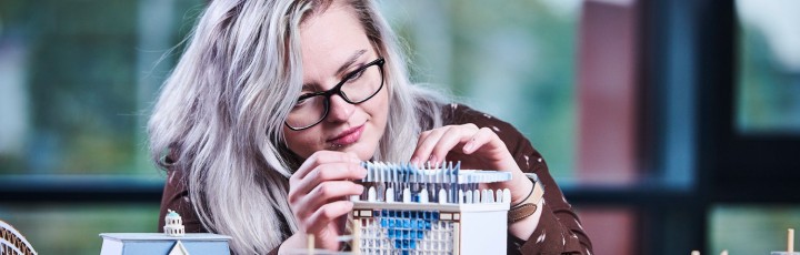 Architecture student assembling a model